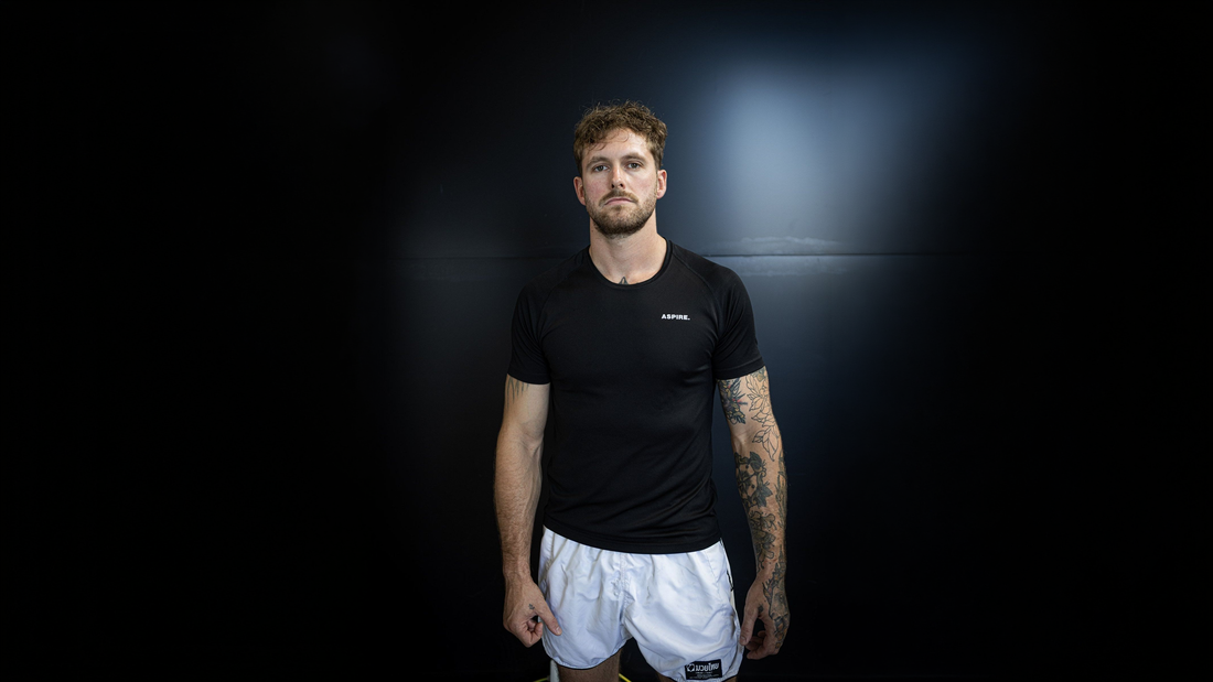 ASPIRE. athlete standing front-on in the Founders Tee, full fit from shoulders to hem visible