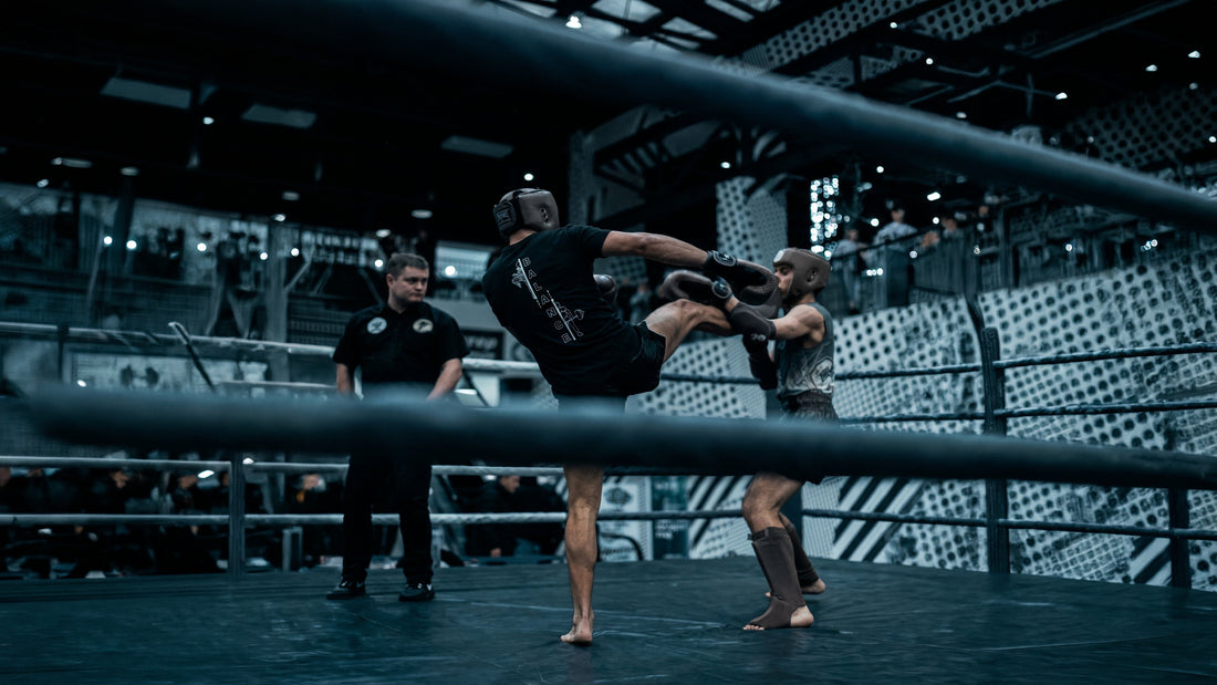 Muay Thai fighter in the ASPIRE. Balance tee throwing a barefoot kick in the ring
